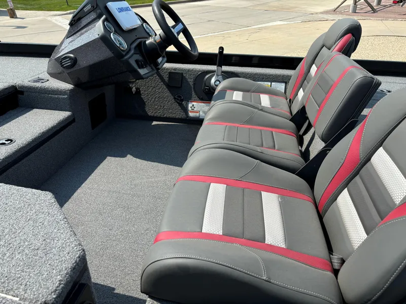 Slide: The Image of 2023 Ranger RT178 boat interior with gray and red seats, steering console, and carpeted flooring. - 4