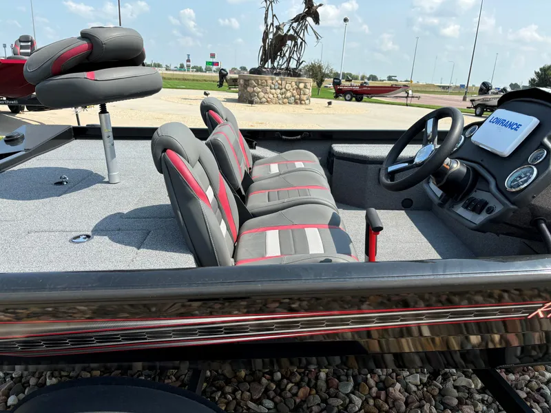 Slide: The Image of 2023 Ranger RT178 boat interior with gray and red seating, steering wheel, and dashboard. - 5