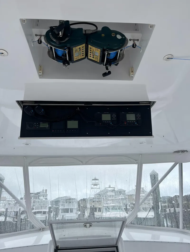 Slide: The Image of 1985 Hines-Farley Custom Express boat interior with control panel and fishing equipment. - 11