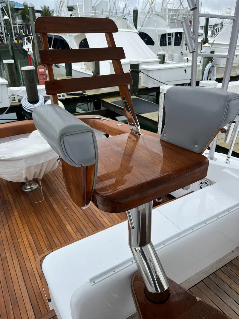 Slide: The Image of 1985 Hines-Farley Custom Express boat with polished wood and metal chair on deck. - 12