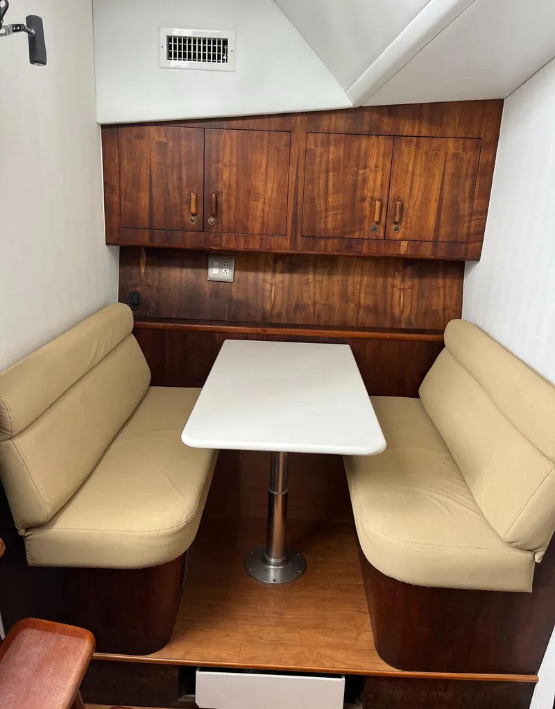 Slide: The Image of 1985 Hines-Farley Custom Express interior with beige seating and wooden cabinetry. - 14