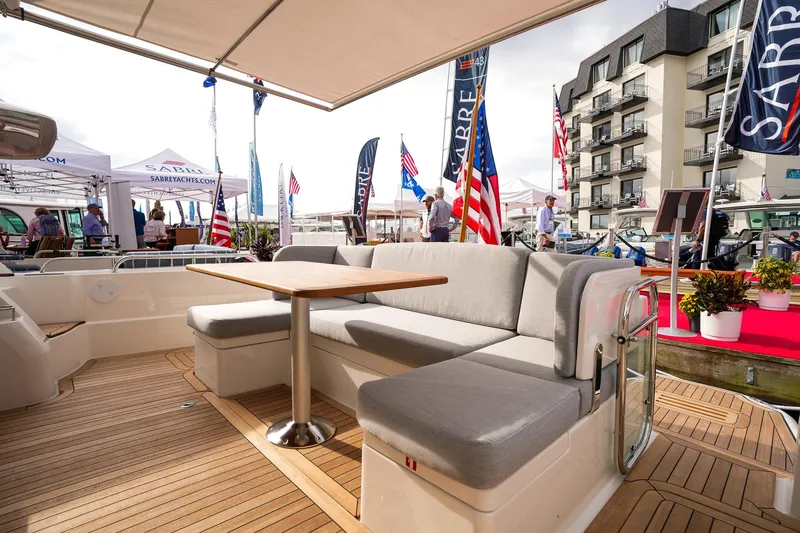 Slide: The Image of Sabre 45 Salon Express 2025 yacht interior with seating and table at a boat show. - 19