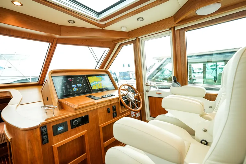 Slide: The Image of Interior of 2025 Sabre 45 Salon Express yacht with modern helm and luxurious seating. - 24