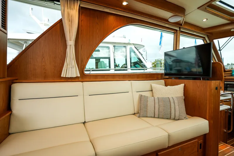 Slide: The Image of Interior of 2025 Sabre 45 Salon Express yacht with cream sofa and TV. - 28