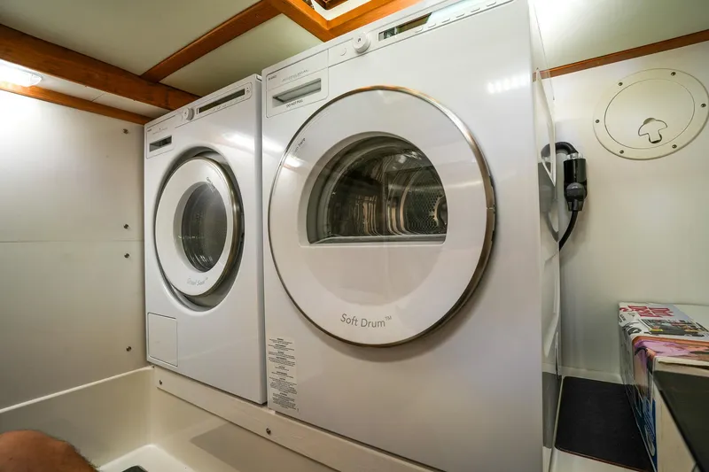 Slide: The Image of Laundry area in 2025 Sabre 45 Salon Express yacht with washer and dryer. - 30