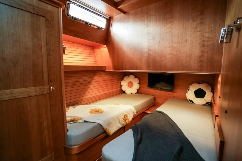 Slide: The Image of 2025 Sabre 45 Salon Express cabin with twin beds and cozy decor. - 33