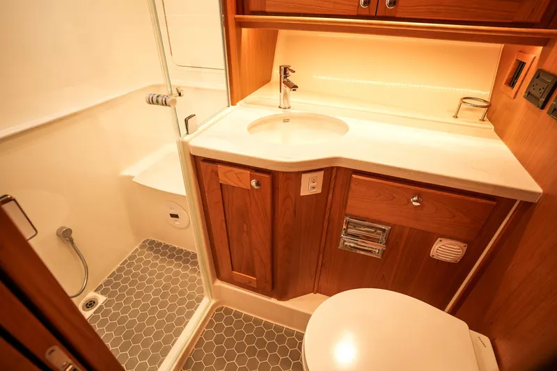 Slide: The Image of Luxurious bathroom in 2025 Sabre 45 Salon Express yacht with modern fixtures and wood cabinetry. - 37
