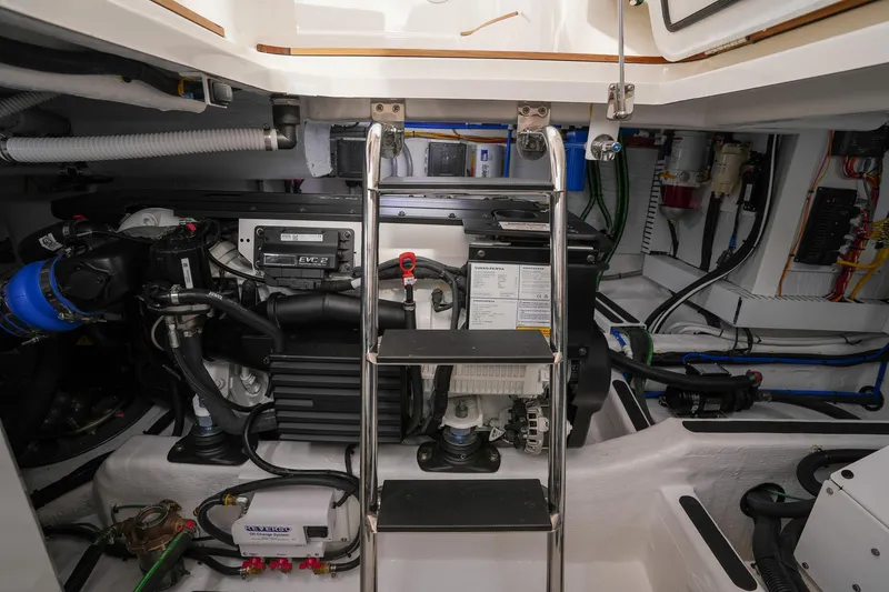 Slide: The Image of Engine room of 2025 Sabre 45 Salon Express with ladder and mechanical components. - 39