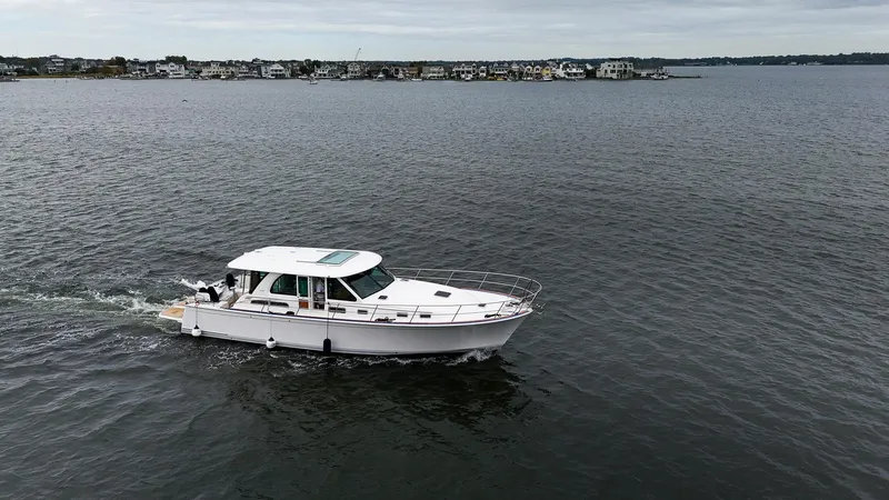 Slide: The Image of 2025 Sabre 45 Salon Express cruising on a calm lake. - 7