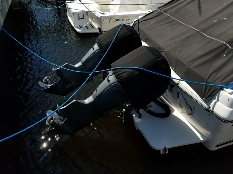 Slide: The Image of 2006 Stamas 320 Express boat with dual outboard motors docked in marina. - 11