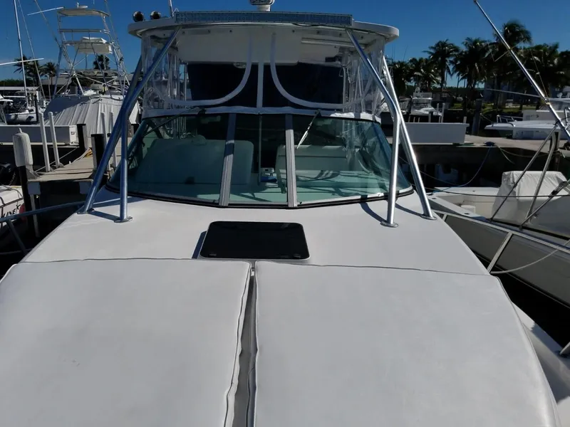Slide: The Image of 2006 Stamas 320 Express boat docked at marina with clear blue sky. - 12