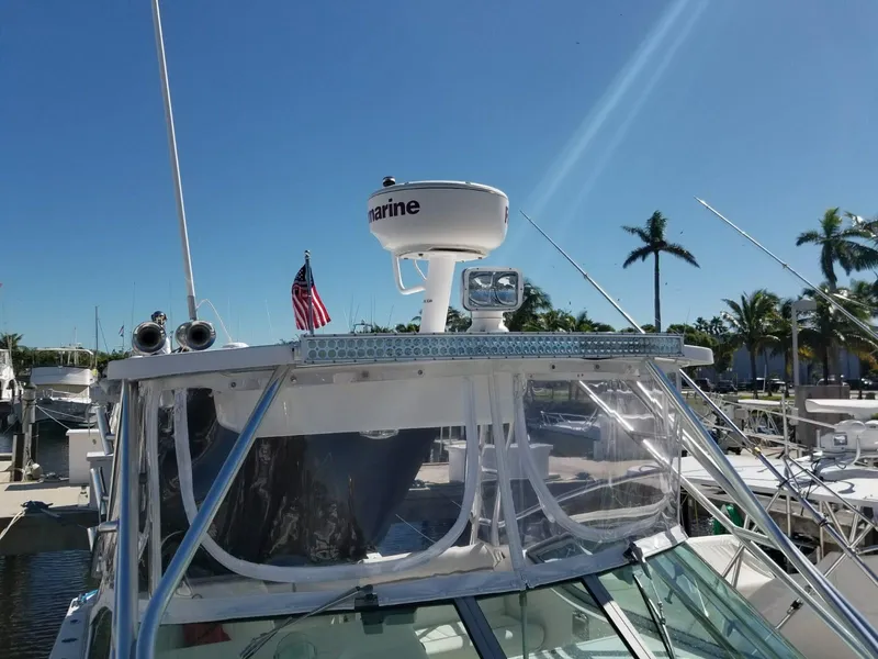 Slide: The Image of 2006 Stamas 320 Express boat docked, featuring radar and American flag. - 14