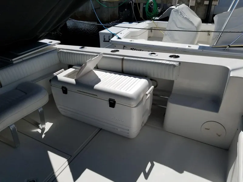 Slide: The Image of 2006 Stamas 320 Express boat interior with seating and cooler. - 15