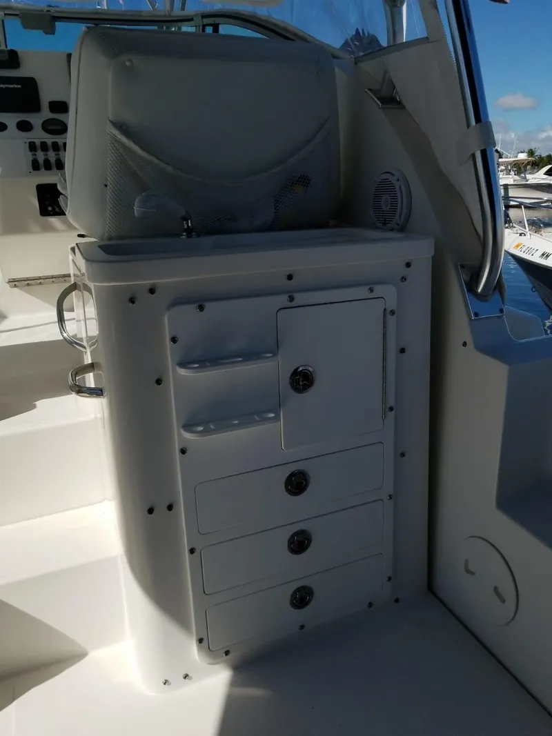 Slide: The Image of 2006 Stamas 320 Express boat interior with storage compartments and control panel. - 17