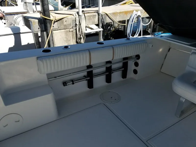 Slide: The Image of 2006 Stamas 320 Express boat interior with rod holders and seating area. - 18