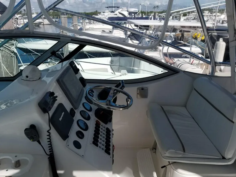 Slide: The Image of 2006 Stamas 320 Express boat cockpit with steering wheel and control panel at marina. - 20
