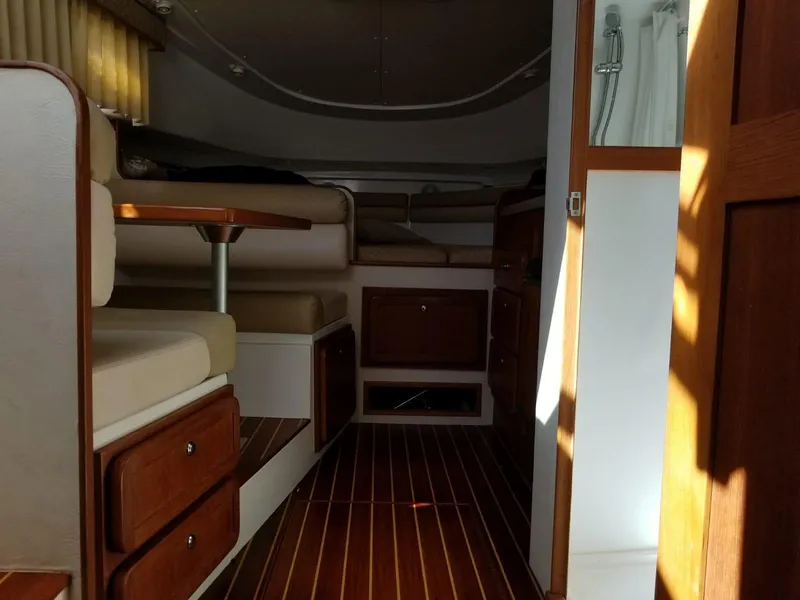 Slide: The Image of Interior of 2006 Stamas 320 Express boat with wood accents and seating area. - 21