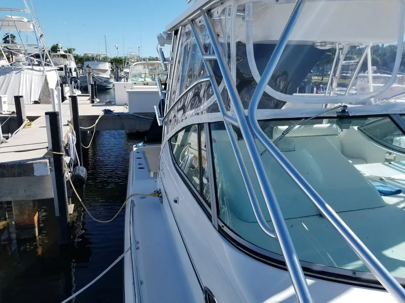 Slide: The Image of 2006 Stamas 320 Express boat docked at marina, featuring sleek design and sturdy structure. - 22