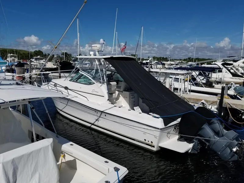 Slide: The Image of 2006 Stamas 320 Express boat docked at marina under clear blue sky. - 24
