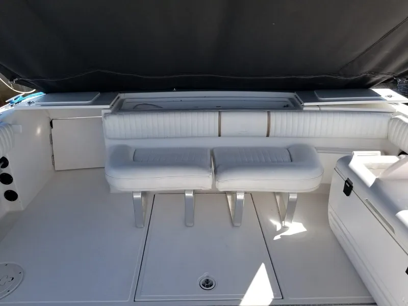 Slide: The Image of 2006 Stamas 320 Express boat interior with white seating and storage compartments. - 26