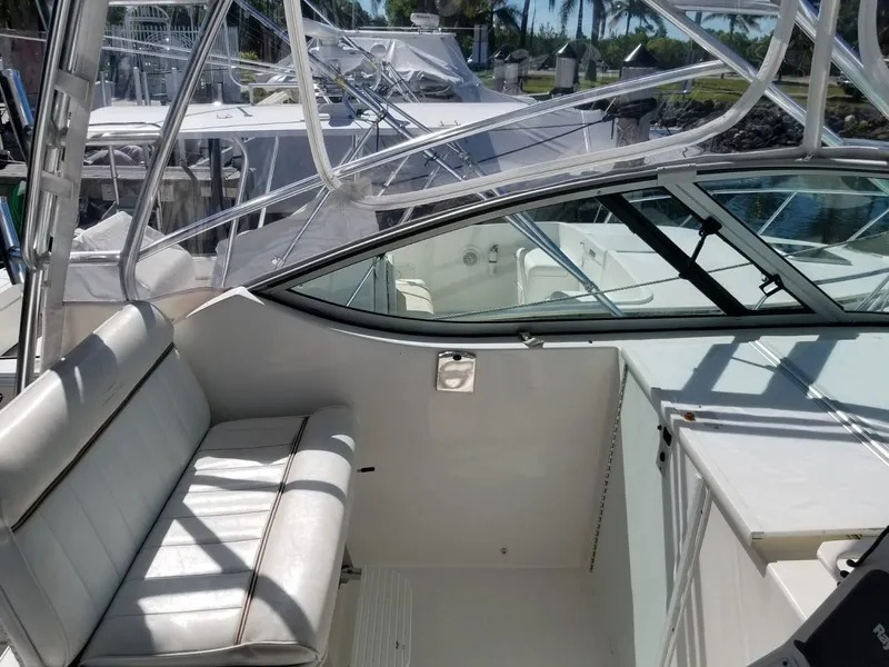 Slide: The Image of 2006 Stamas 320 Express boat interior with white seating and clear canopy. - 27