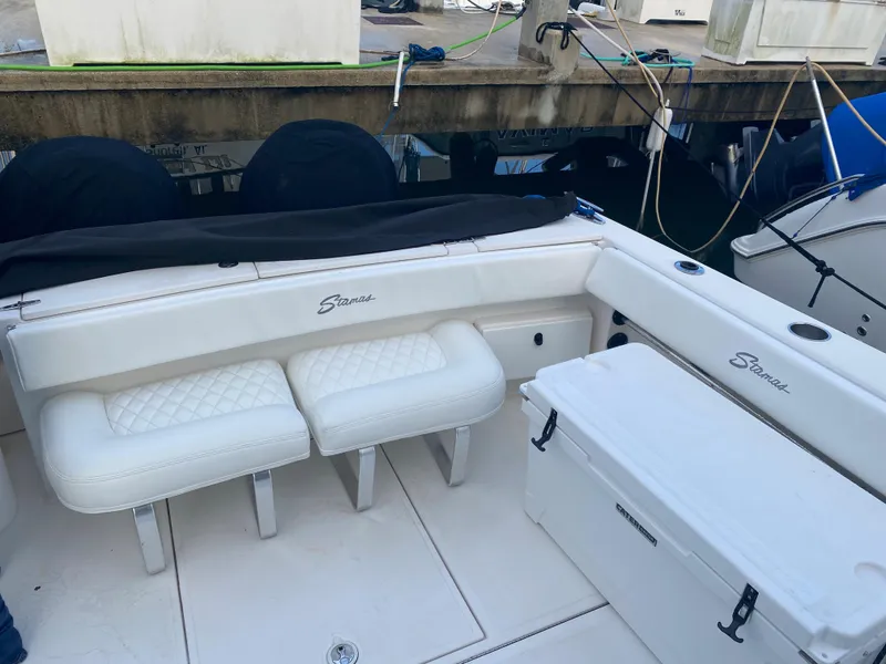 Slide: The Image of 2006 Stamas 320 Express boat interior with white seating and storage. - 4