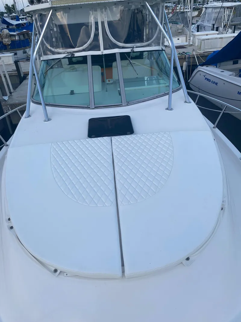 Slide: The Image of 2006 Stamas 320 Express boat with spacious deck and sleek design at marina. - 7