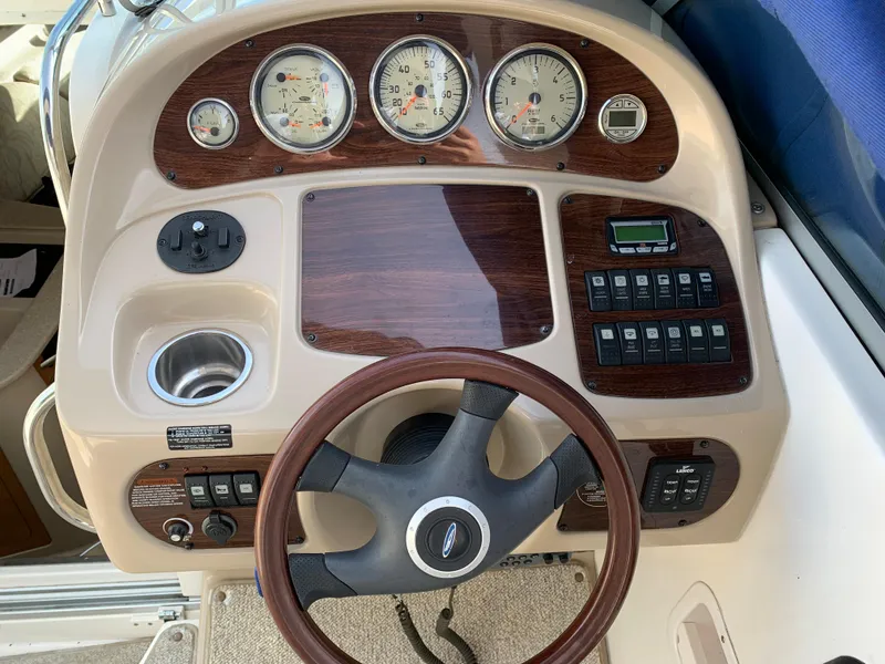 Slide: The Image of 2006 Chaparral 276 Signature boat dashboard with steering wheel, gauges, and control panel. - 10