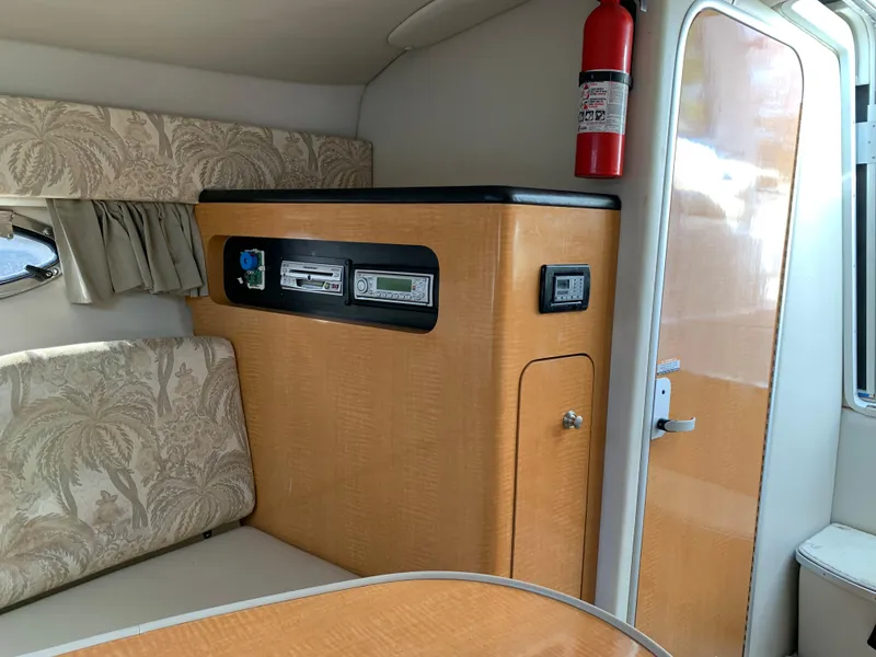 Slide: The Image of Interior of 2006 Chaparral 276 Signature boat with wood finish and fire extinguisher. - 15