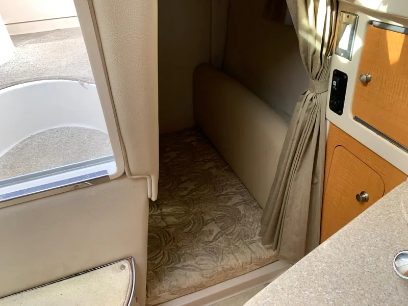 Slide: The Image of Interior cabin of a 2006 Chaparral 276 Signature boat with beige upholstery. - 18