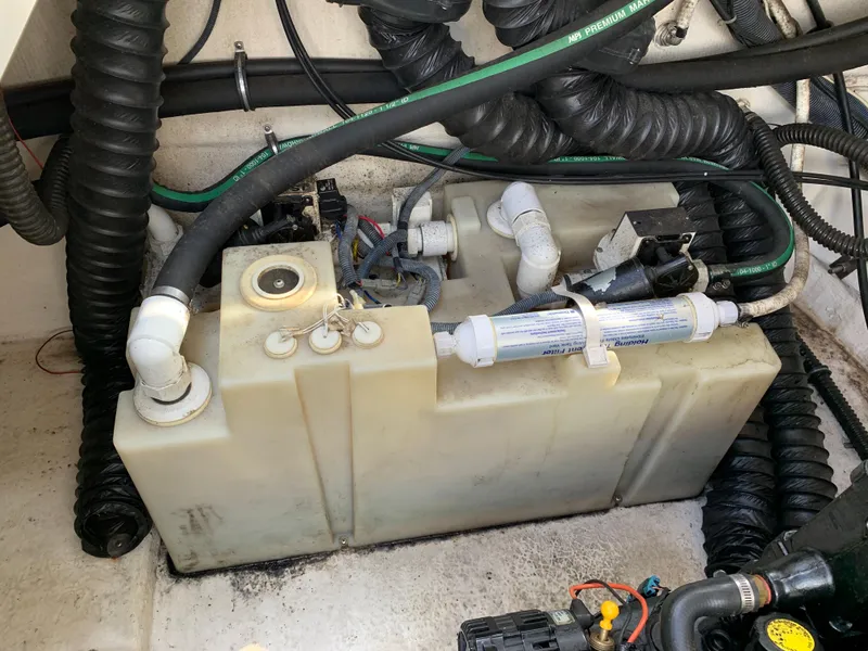 Slide: The Image of 2006 Chaparral 276 Signature boat engine compartment with water tank and hoses. - 26