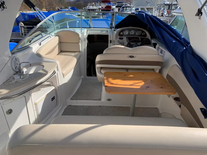 Slide: The Image of 2006 Chaparral 276 Signature boat interior with seating and wooden table. - 5