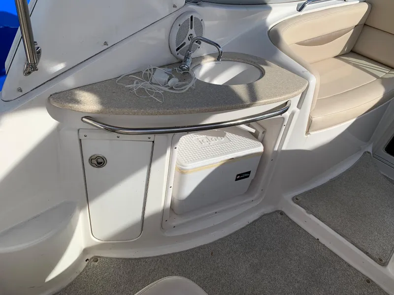 Slide: The Image of 2006 Chaparral 276 Signature boat interior with sink and storage compartment. - 6