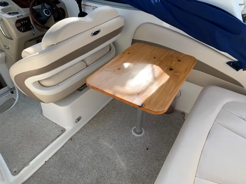 Slide: The Image of Interior of 2006 Chaparral 276 Signature boat with seating and wooden table. - 7
