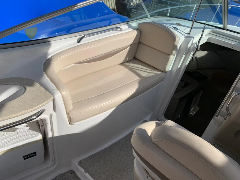 Slide: The Image of 2006 Chaparral 276 Signature boat interior with beige seating and storage compartment. - 8