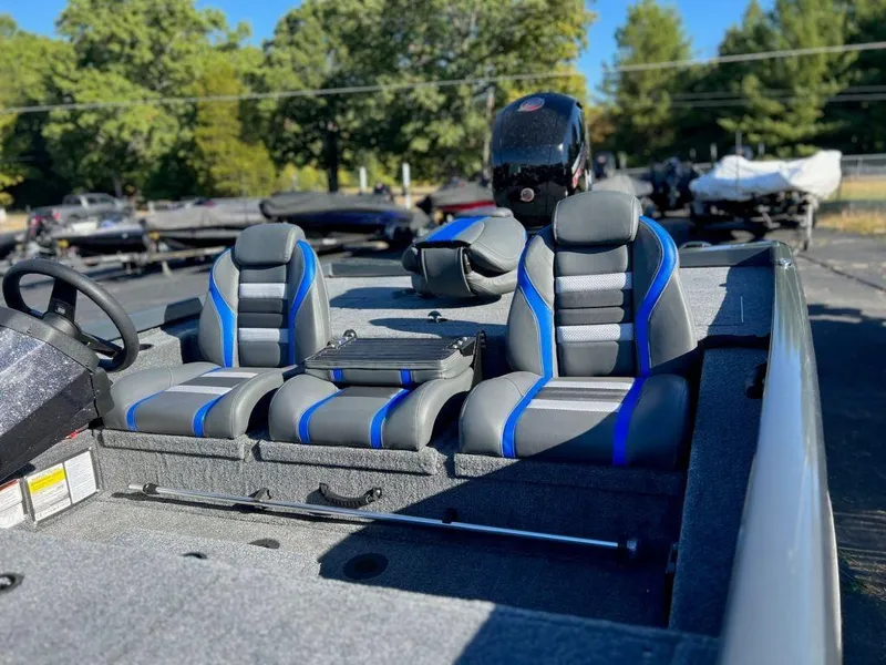 Slide: The Image of 2023 Ranger RT198P boat interior with dual seats and steering wheel, outdoors. - 12