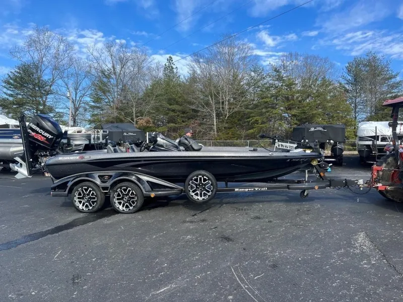 The Image of 2014 Ranger Z520C bass boat on a trailer in a parking lot. - 1