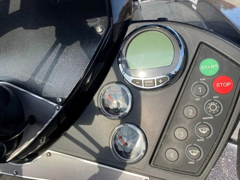 Slide: The Image of 2014 Ranger Z520C boat dashboard with gauges and control buttons. - 10