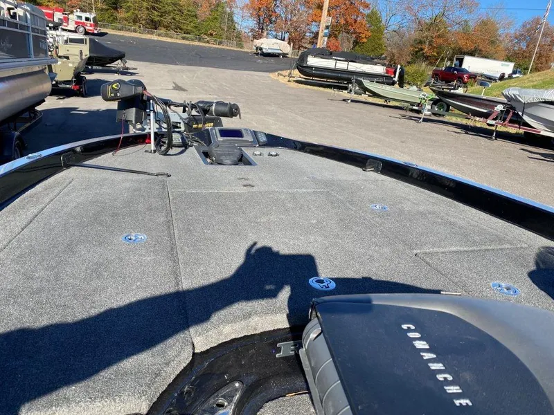 Slide: The Image of 2014 Ranger Z520C boat deck with fishing equipment, parked outdoors. - 1