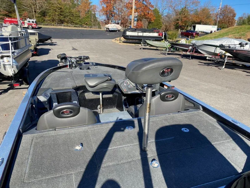 Slide: The Image of 2014 Ranger Z520C fishing boat with seating and control panel, parked outdoors. - 11