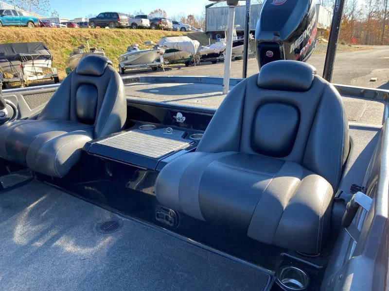 Slide: The Image of 2014 Ranger Z520C boat interior with two black seats and storage compartment. - 2
