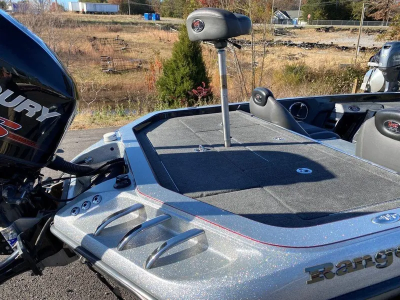 Slide: The Image of 2014 Ranger Z520C boat with Mercury engine, featuring spacious deck and seating. - 21