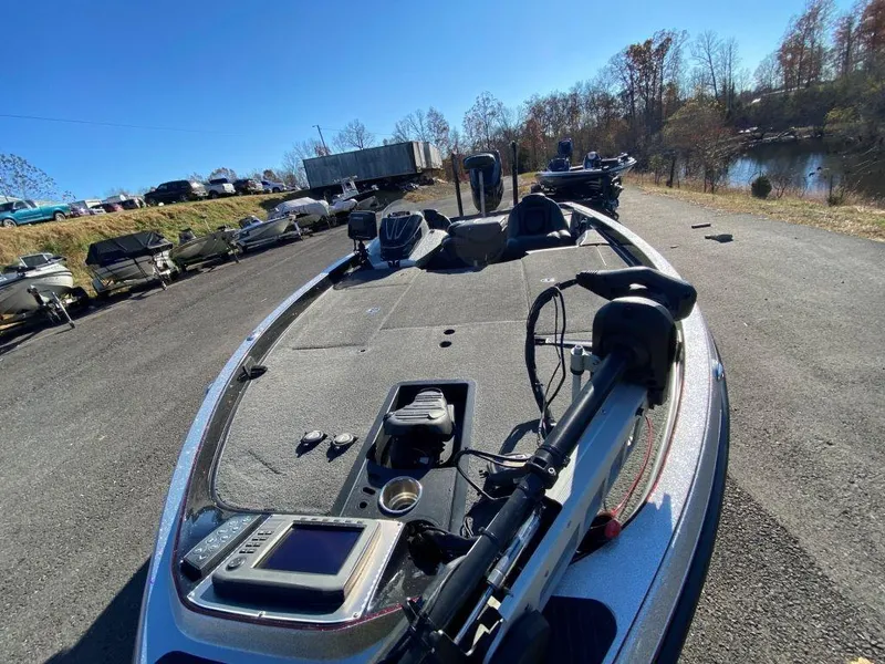 Slide: The Image of 2014 Ranger Z520C bass boat on a sunny day, parked near a lake. - 4