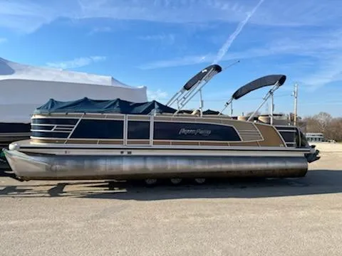 Slide: The Image of 2019 Godfrey 259CBD pontoon boat with blue and tan accents, docked on land. - 17