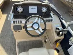 Slide: The Image of 2019 Godfrey 259CBD boat dashboard with steering wheel and control panel. - 4