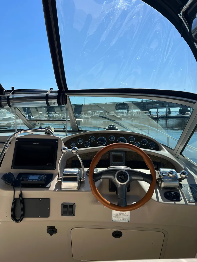 Slide: The Image of 2000 Sea Ray 34 DA boat helm with steering wheel and control panel. - 11