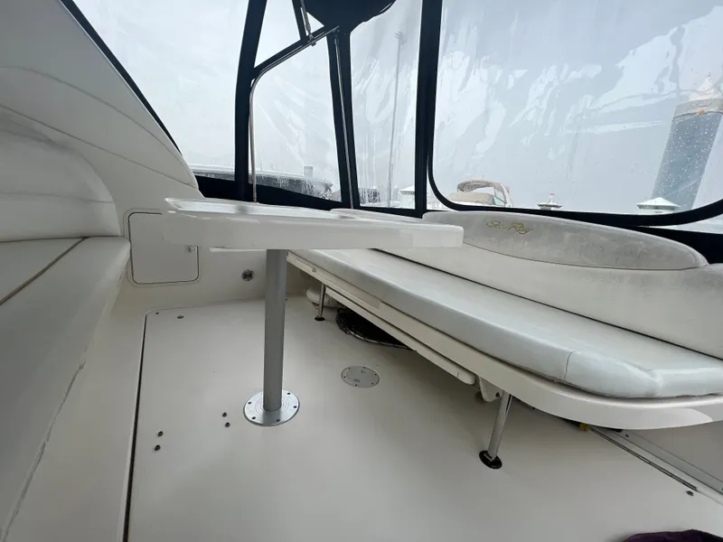 Slide: The Image of Interior seating area of a 2000 Sea Ray 34 DA boat with white upholstery. - 12