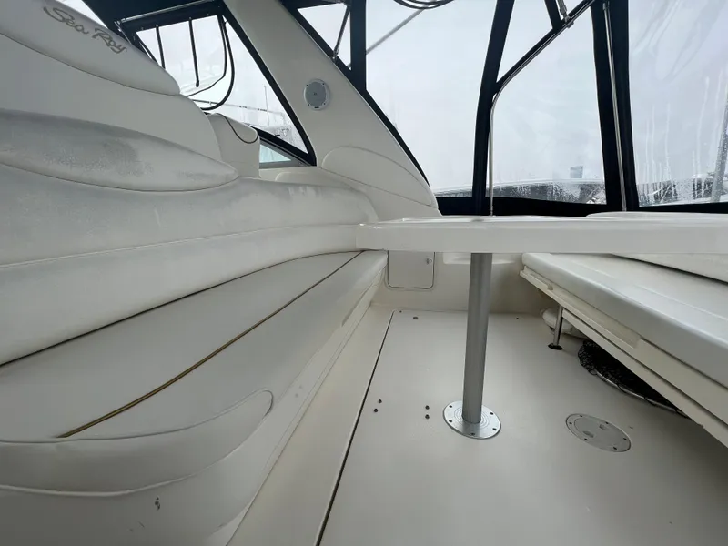 Slide: The Image of Interior seating area of a 2000 Sea Ray 34 DA boat with white upholstery. - 14