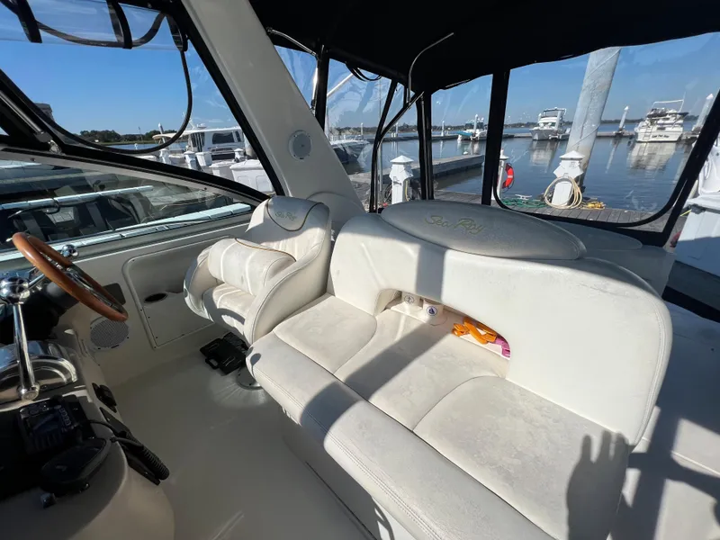 Slide: The Image of Interior of 2000 Sea Ray 34 DA boat with white seating and marina view. - 17