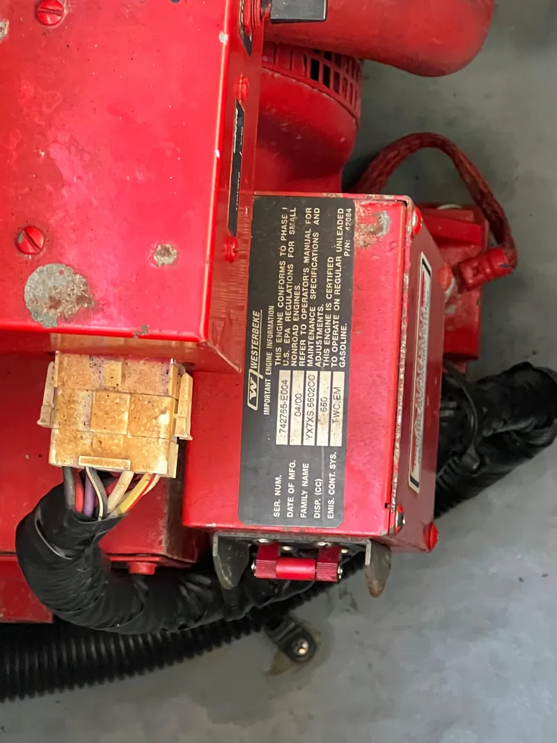 Slide: The Image of Close-up of a red engine component from a 2000 Sea Ray 34 DA boat. - 22